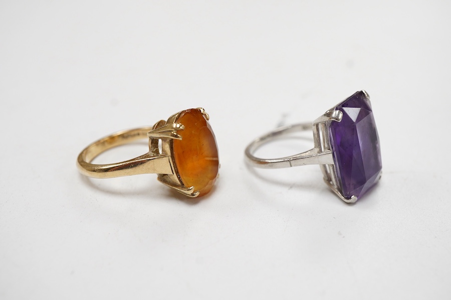 Two dress rings: one a rectangular cut amethyst set in platinum, size M and a 9ct gold and oval cut citrine, size L.